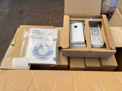 a box with a remote, a dvd, and a cd in it