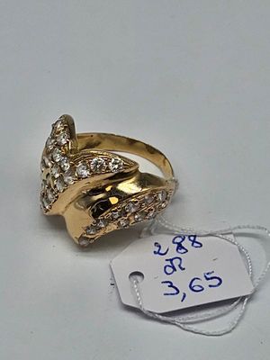 a gold ring with diamonds on it and a price tag