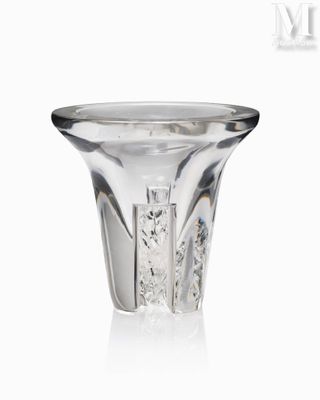 a glass vase that is sitting on a white surface
