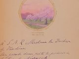 an old book with a picture of a tree in a field