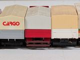 a lot of toy trains that are lined up on a table