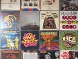 a lot of records on the wall of a room