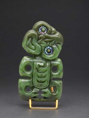 an image of a green sculpture with a face on it