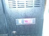 a metal cabinet with a sign on it in a room
