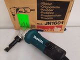 a close up of a corded drill with a box in the background