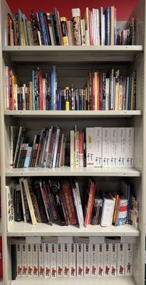 a book shelf with many books on it in a library