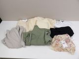 a lot of clothes that are on a white table