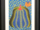 a painting of a blue and yellow cactus with a red apple on top