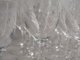 many empty wine glasses lined up on a table
