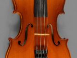 a close up of a violin on a gray surface