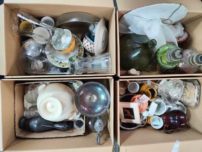 two boxes filled with assorted items sitting on top of a table