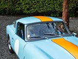 an image of a blue and orange car parked in a parking lot