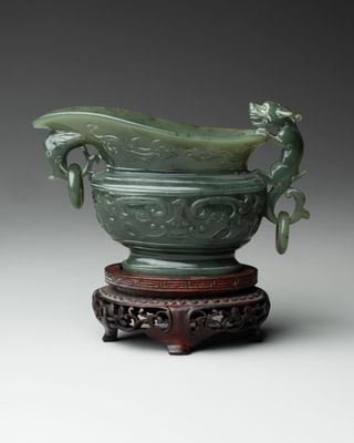an image of a green vase with a dragon on top of it