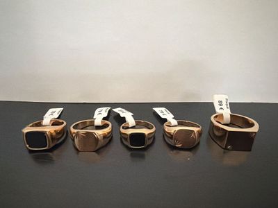 several different types of rings are lined up on a table