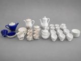 a group of white and blue dishes and cups and saucers