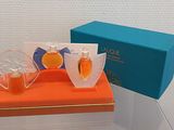 two bottles of perfume sitting on top of an orange box