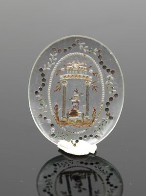 a glass plate with a picture on it on a table