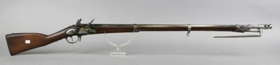 an old gun with a wooden handle on a white surface
