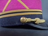 a purple hat with a gold ribbon on it