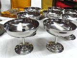 a table with a lot of silver dishes on it