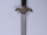 a sword with a black handle on a white background