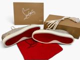 christian louvignon ' s red and white sneakers are on display in front of a box