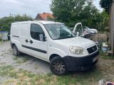 a white van parked in a yard next to a building