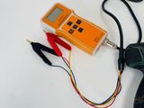 a corded drill and a remote control on a table