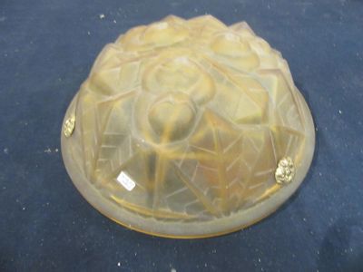 a glass cake pan with a yellow frosting on it