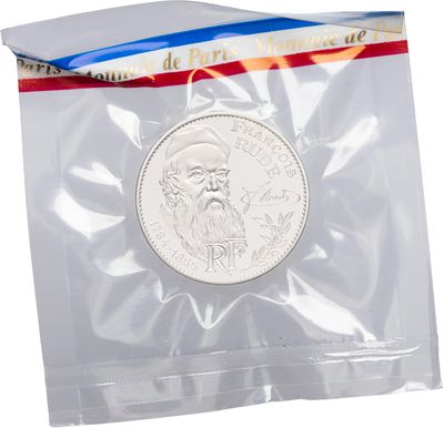 a close up of a coin in a plastic bag on a white background