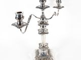 a silver candelab with two candles on top of it