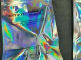 two packets of condoms sitting on a table next to a pair of scissors