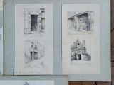 several drawings of buildings are on display on a wooden floor