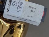 a gold statue that has a price tag attached to it
