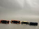 four toy cars sitting next to each other on a table