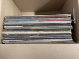 an open cardboard box filled with lots of cds and cds