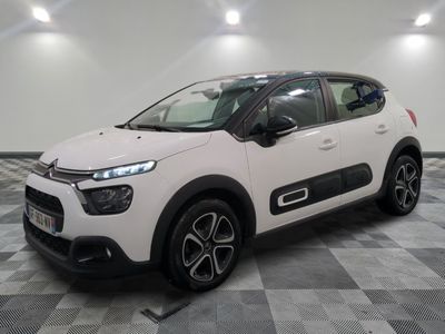 the white citrole is parked on a checkered tile floor