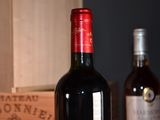 a bottle of wine sitting on a table next to a box of wine