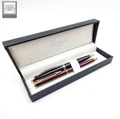 the pen is in a black box with a gold trim