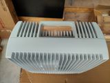 a white air conditioner sitting on top of a cardboard box