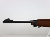 a close up of a rifle on a stand on a white surface