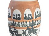 a vase that has a picture of a horse race on it