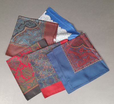 four different colors of handkerchiefs on a table