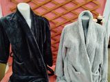 two robes on display on a table in a store