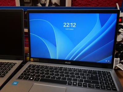 two laptops sitting side by side on a table
