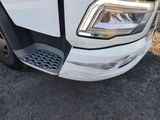 a close up of a white truck with a black stripe on the front of it