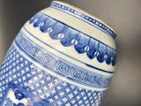 a blue and white vase sitting on top of a table