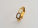 a close up of a gold ring on a white surface