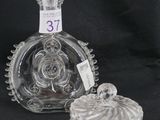 une bouteille en verre avec un bouchon, posée sur une assiette