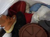 a bag of clothing and shoes inside of a white tent